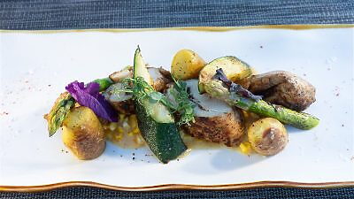 Pelago dish including potatoe, asparagus, corn, and zucchini