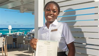 Pelago waitor showing menu and smiling